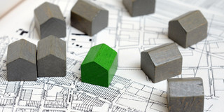 Models of houses Small models of houses are on a building plan.