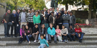 Group picture of the SPRING students in front of a statue