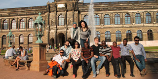 Group picture of SPRING students in front of a monument in Dresden.