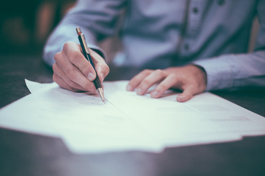 Person signing documents.