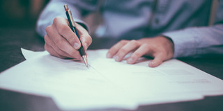 Person signing documents.