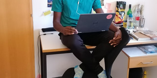 SPRING Online Teaching The picture shows Kabaka Mutensa studying at his desk.