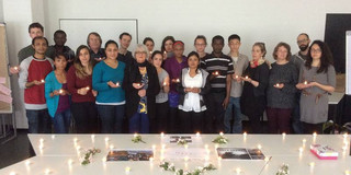 Group picture of SPRING staff and students wih candles in their hands.