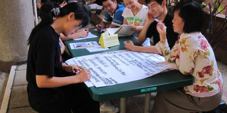 Picture of students working around a table.