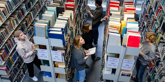 Students search for books in the library.