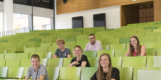 A group of students sit in the lecture hall.