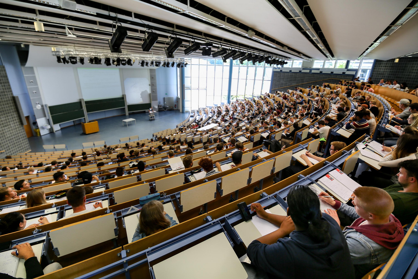 Students sit in a lecture hall.